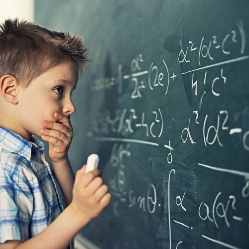 Little boy in math class overwhelmed by the math formula. Little boy in math class overwhelmed by the math formula.
